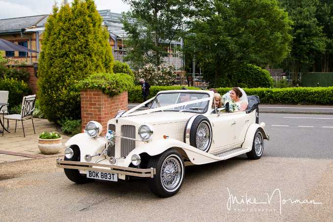 Bride and Groom arriving at Hadley Park House Hotel in the Beauford wedding car.