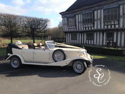 Beauford wedding car at Middleton Hall with the timber framed building in the background.