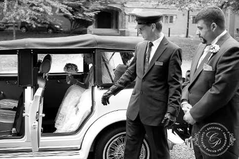 Groom awaiting his Bride to exit the car at Hawkesyard Hall.